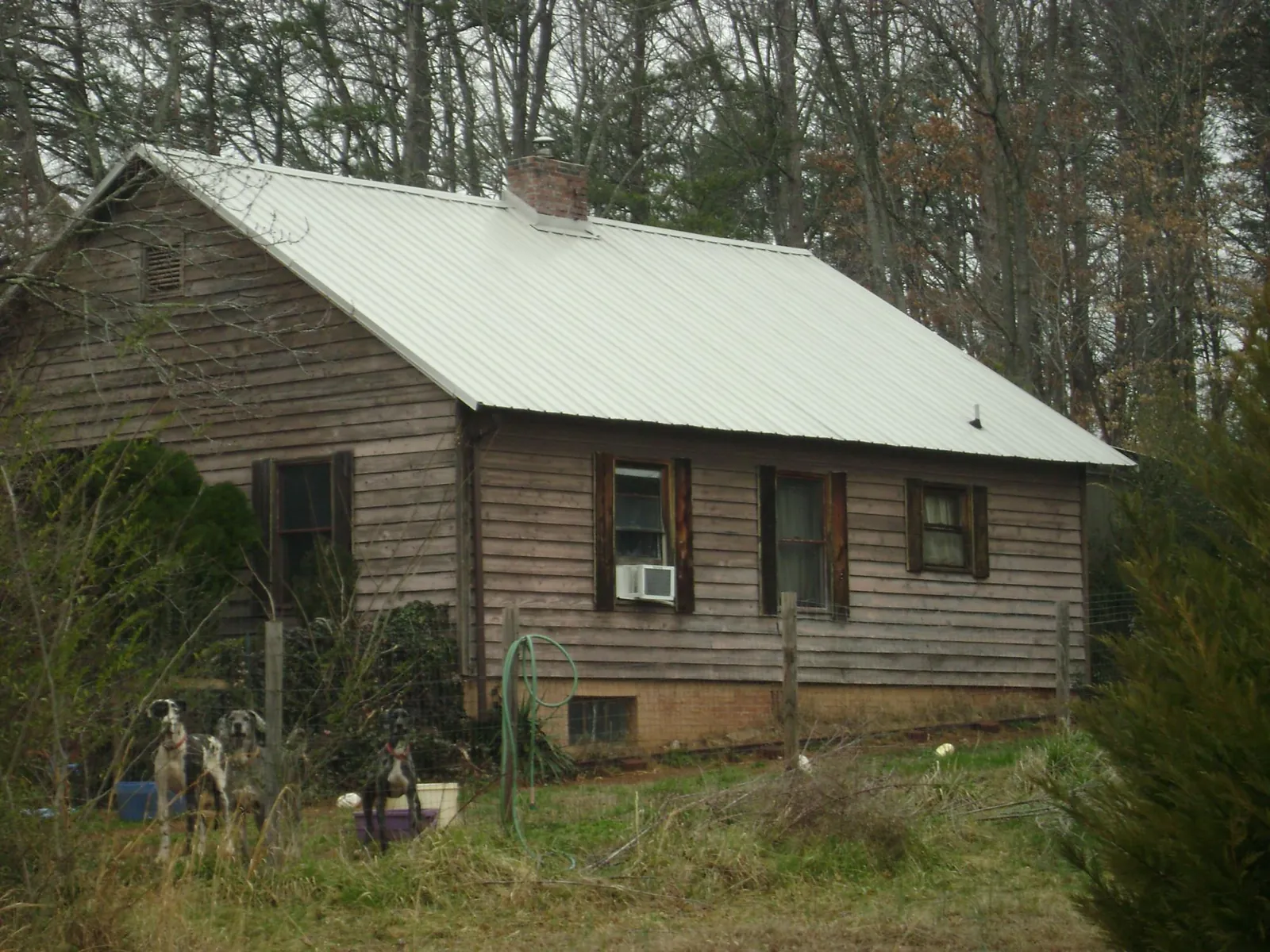 White metal roof on an old wood sided farmhouse, from a Metal Roof Installation job in West Point